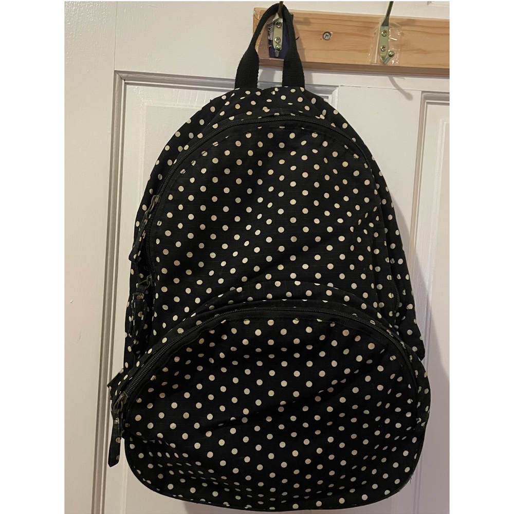 Black backpack with white polka dots